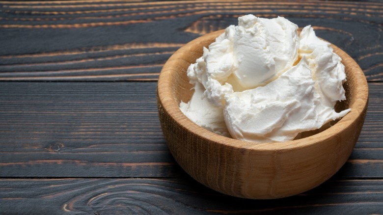 Cream cheese in wooden bowl