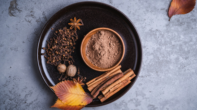 a plate with whole and ground spices