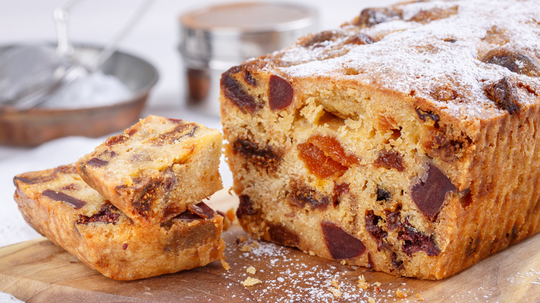 cut fruitcake and slices on a cutting board