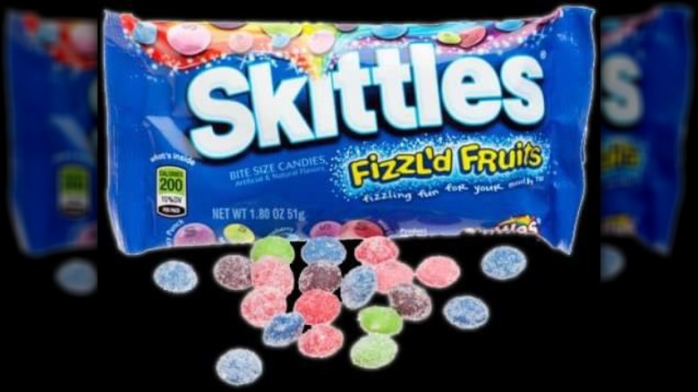 a package of Skittles Fizzl'd Fruits on a black background