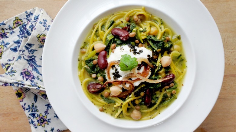 Noodle soup topped with yogurt