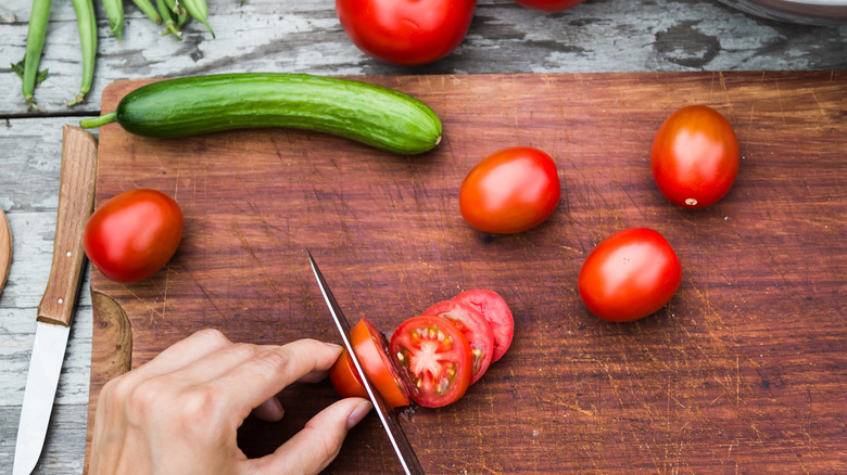 slicing tomatoes and cucumbers