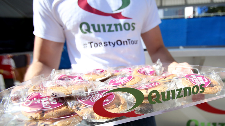 Quiznos employee holding tray