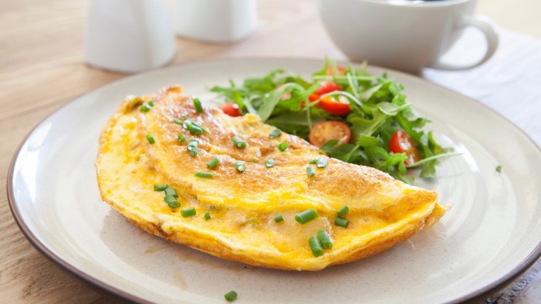 Omelet on plate with salad 