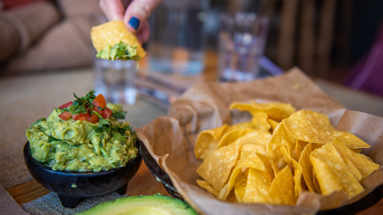 Dipping nacho in guacamole