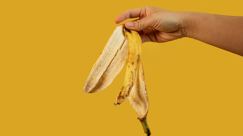 Hand holding a banana peel