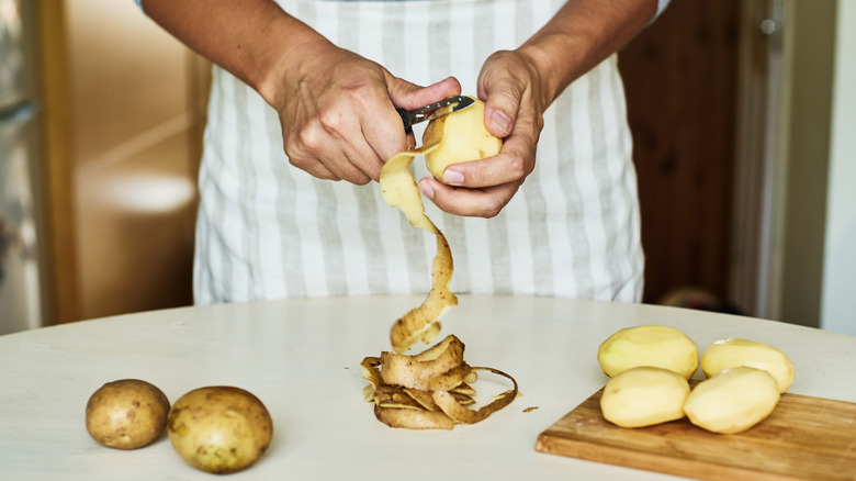 Man peeling a potato