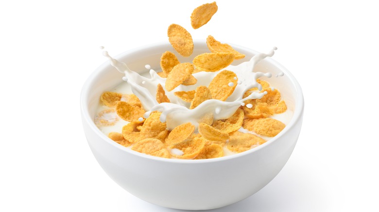 Milk pouring into a bowl of cereal