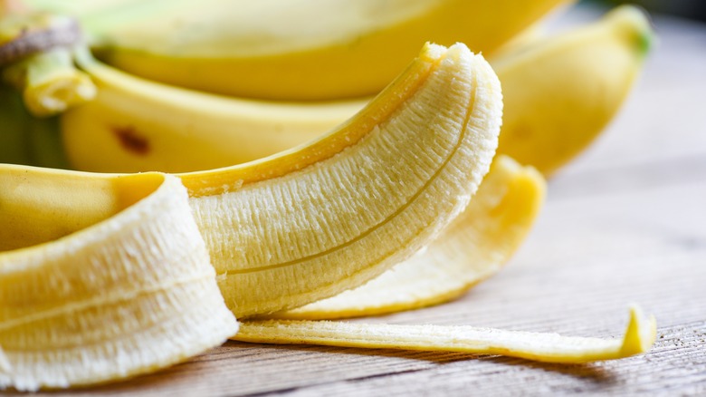 half-peeled banana on wood