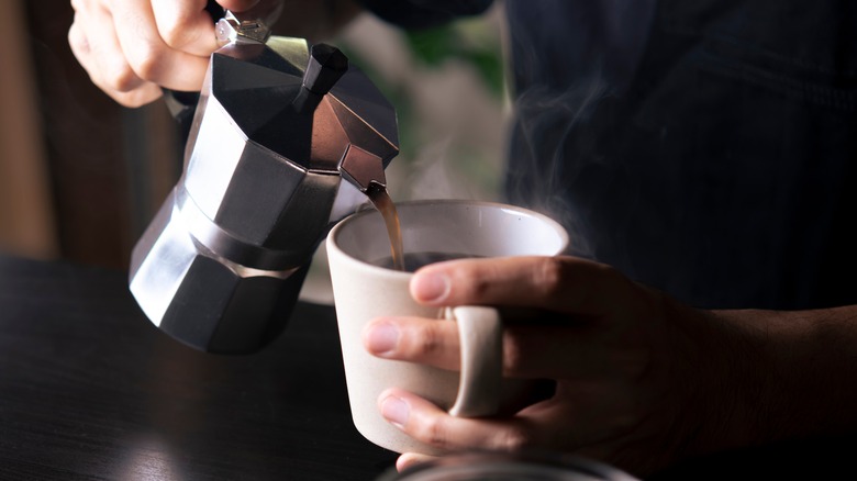 person pouring cup of coffee