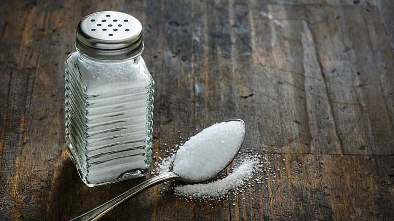 Salt shaker on wooden table