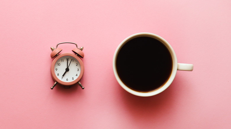 Coffee cup and alarm clock