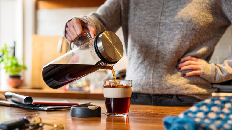 Woman pouring cold brew coffee