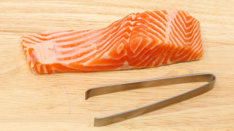 sea trout fillet with deboning tweezers