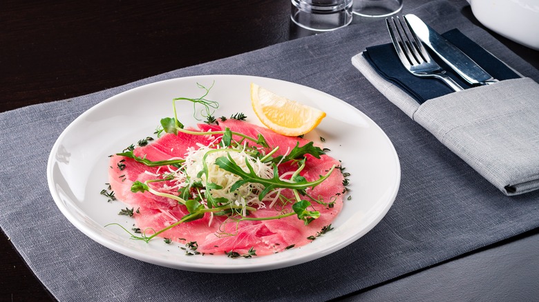 tuna carpaccio on white plate