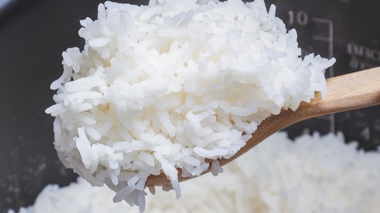 Closeup of white rice on wooden spoon