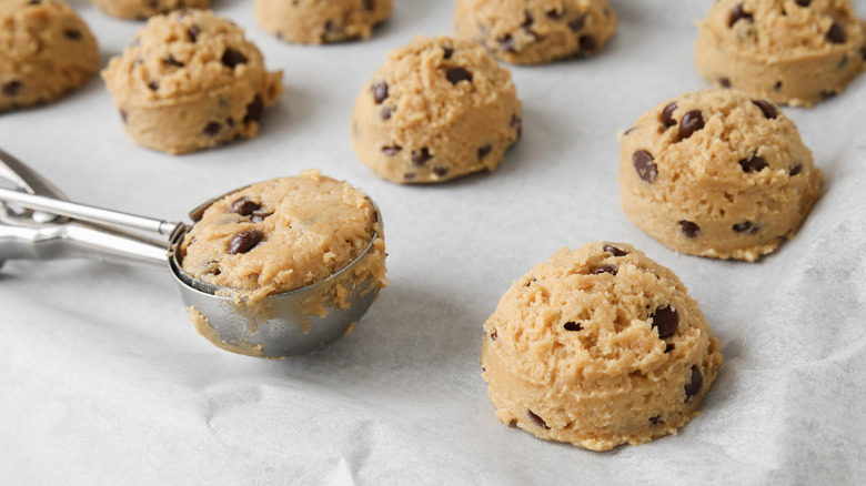 Chocolate chip cookie dough with a scooper