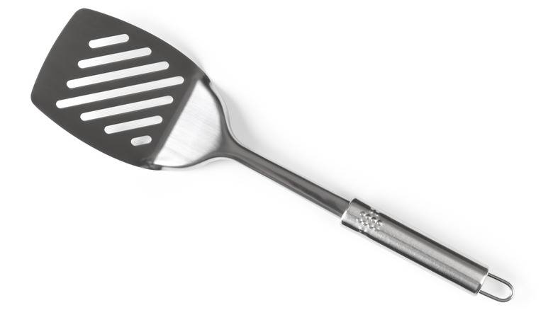 Stainless steel spatula on white background