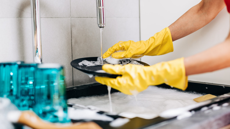 Washing dishes in soapy water