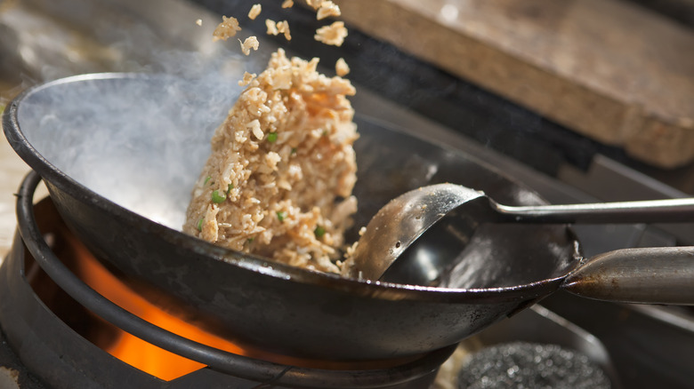 fried rice being cooked in wok