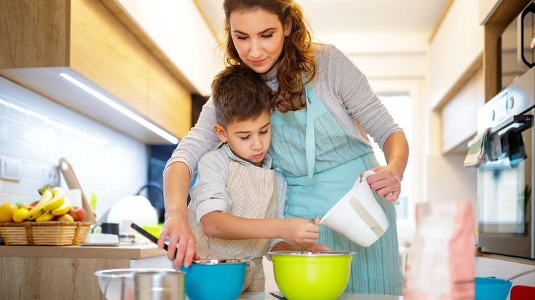 woman and boy with mixing bowls