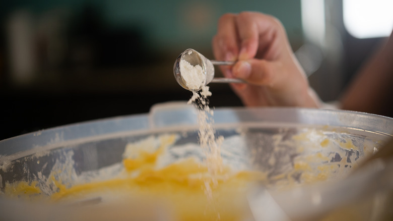 pouring baking soda into bowl