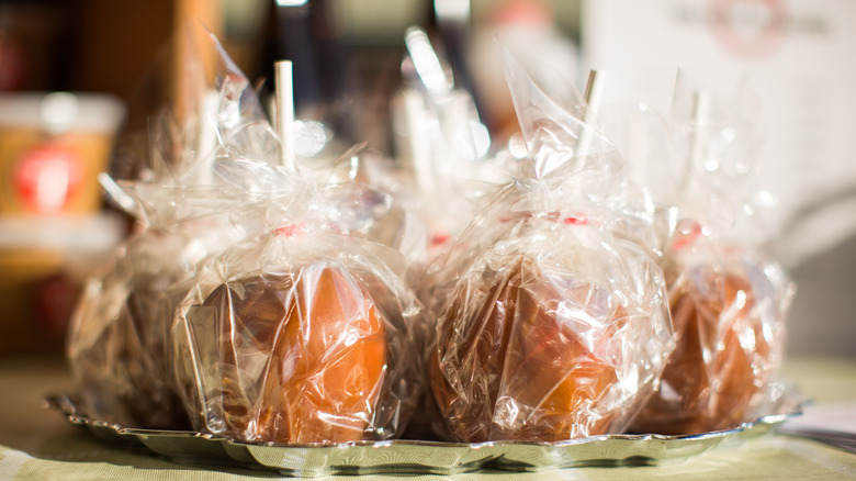 Wrapped caramel apples on tray