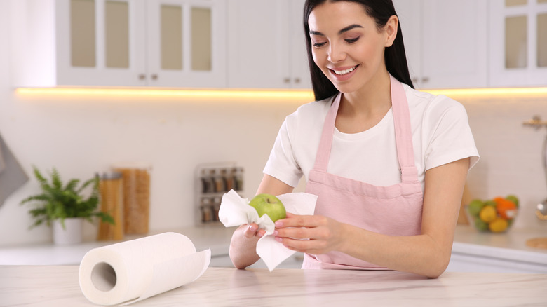 Woman drying off an apple