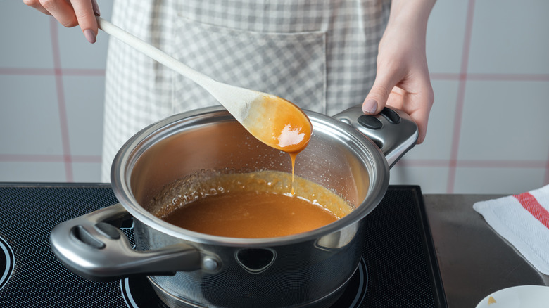 Person stirring caramel with spoon