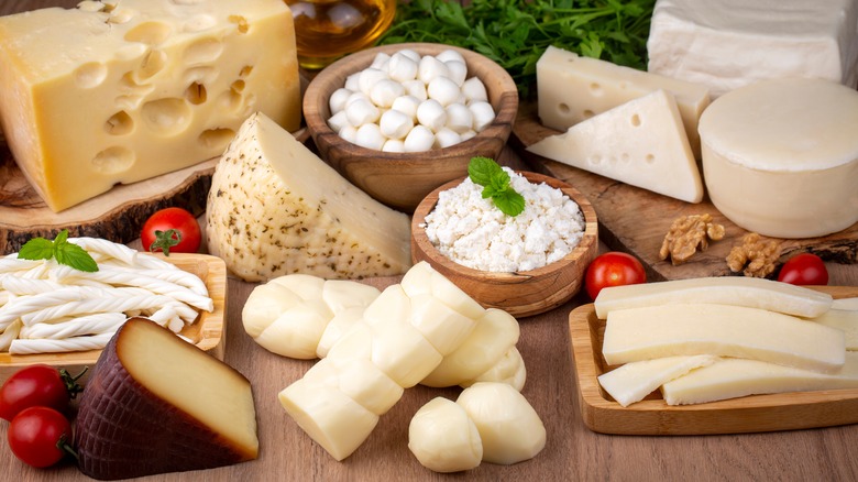 Various cheese on wood board