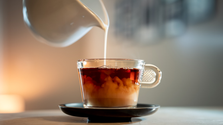 pouring milk into tea