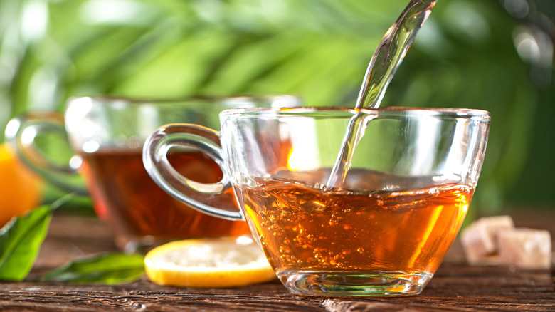 closeup pouring tea in cup