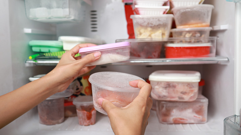 person defrosting things in fridge