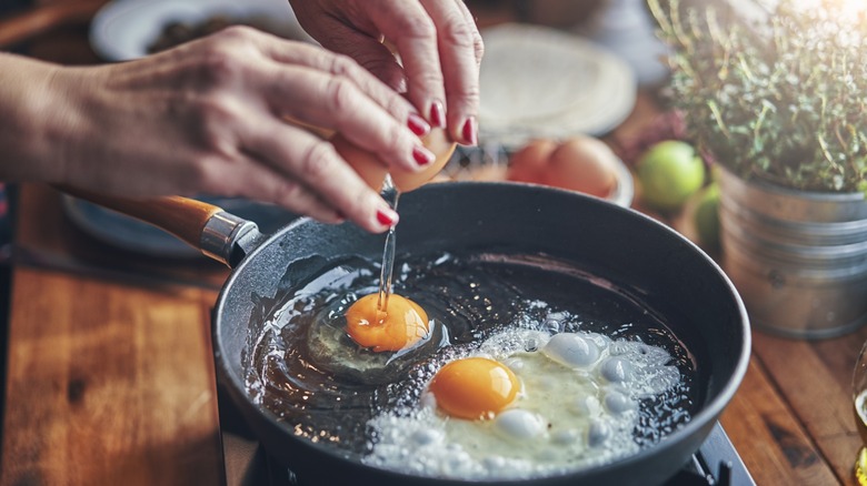 Adding eggs to pan