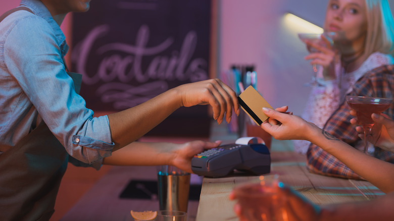 Person paying for drink