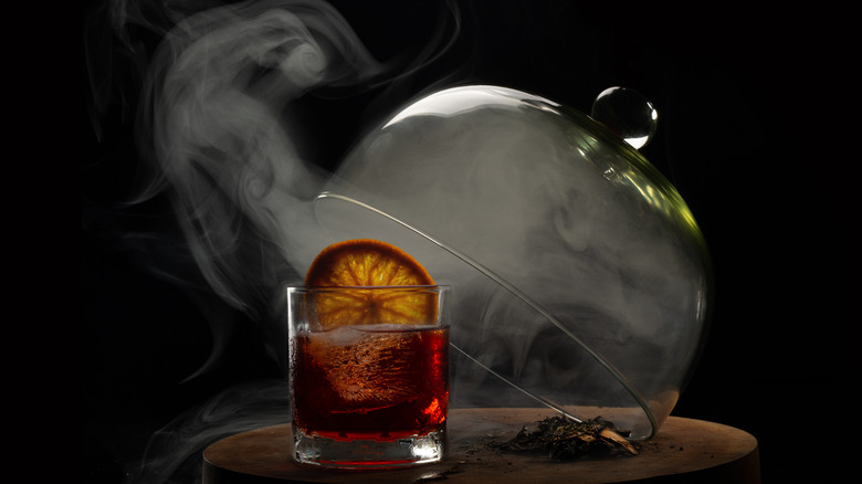 Smoked cocktail under glass dome