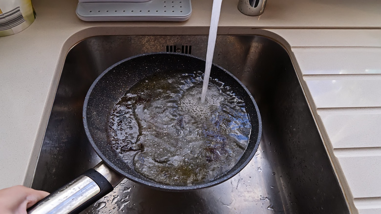 Holding pan under running water