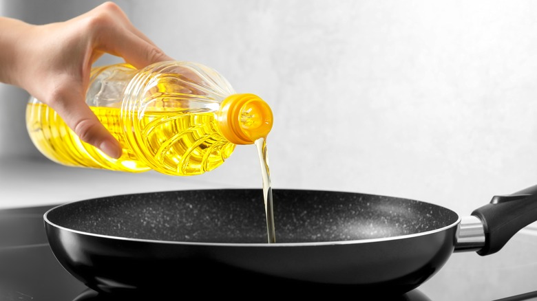 Pouring oil into frying pan