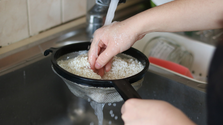 Rinsing rice in colander