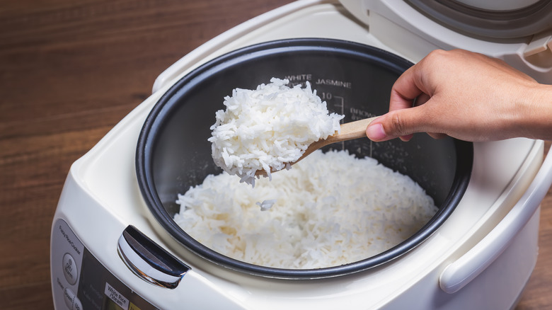 Rice being scooped from rice cooker