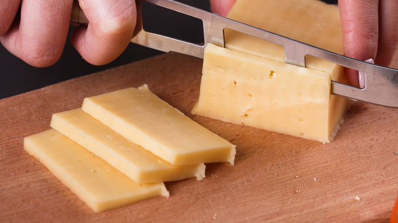 slicing cheese with knife