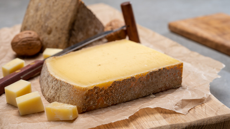 cheese with rind on cutting board