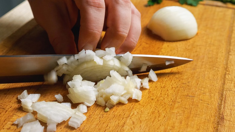 hand dicing onions