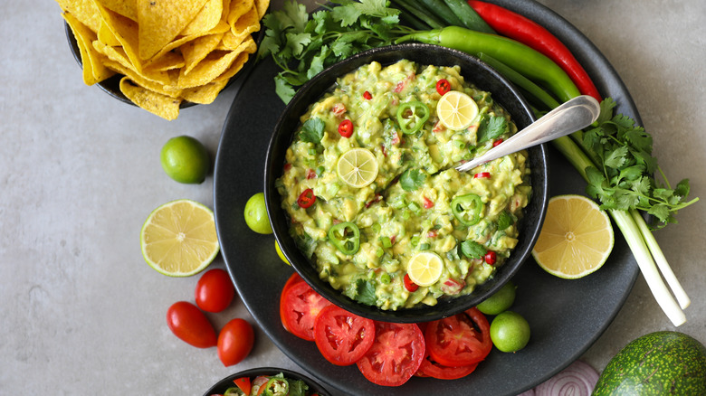 bowl of guacamole with ingredients