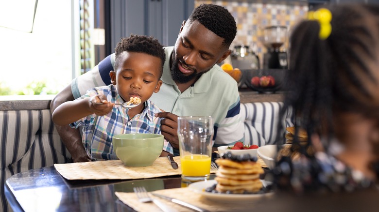 father and son eating cereal