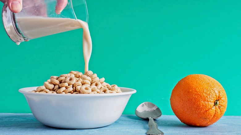 pouring milk into cereal