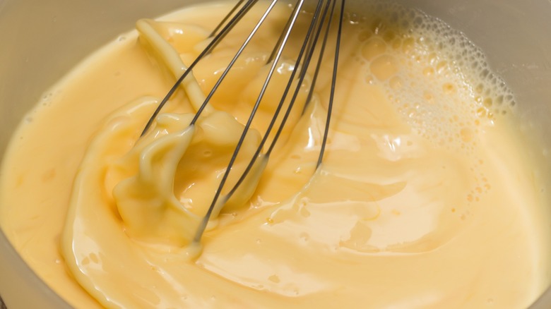 whisking an egg omelet