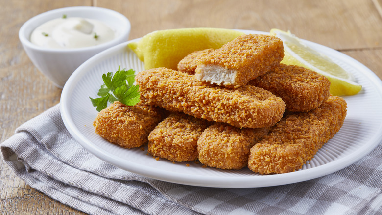 Plate of fish sticks with lemon wedges