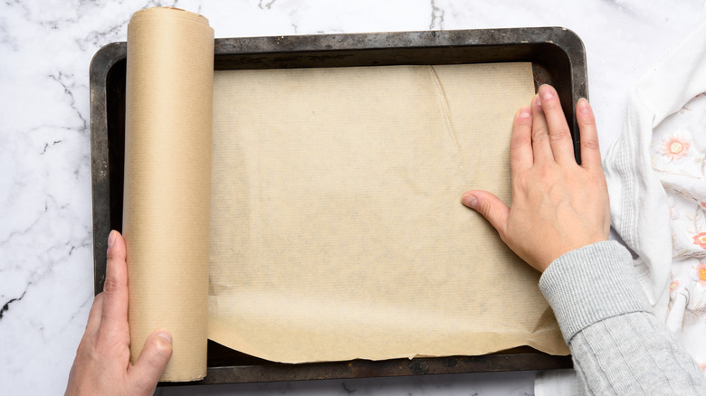 Putting parchment on sheet pan