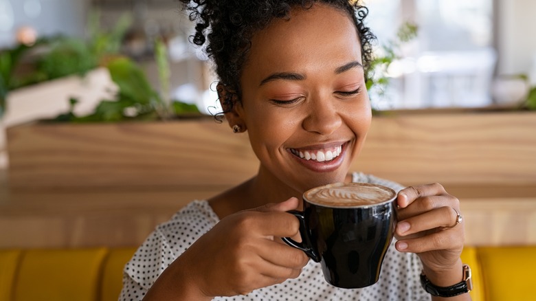 Black woman enjoying hot coffee